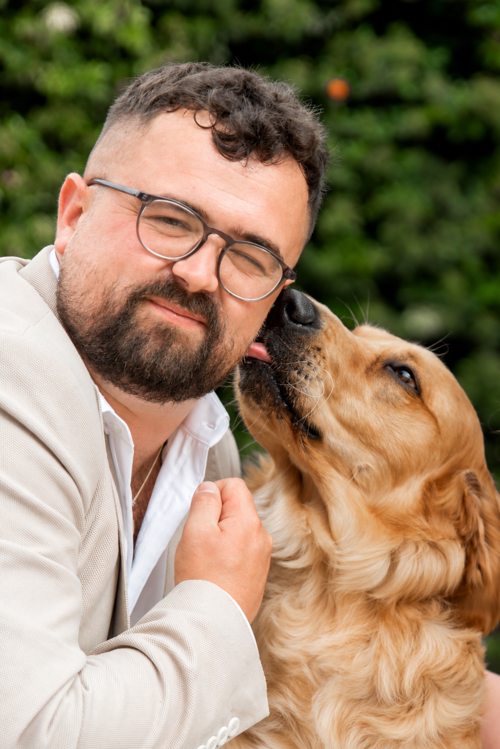 Portrait of Bark & Bramble owner Lewis with Winston the golden retriever